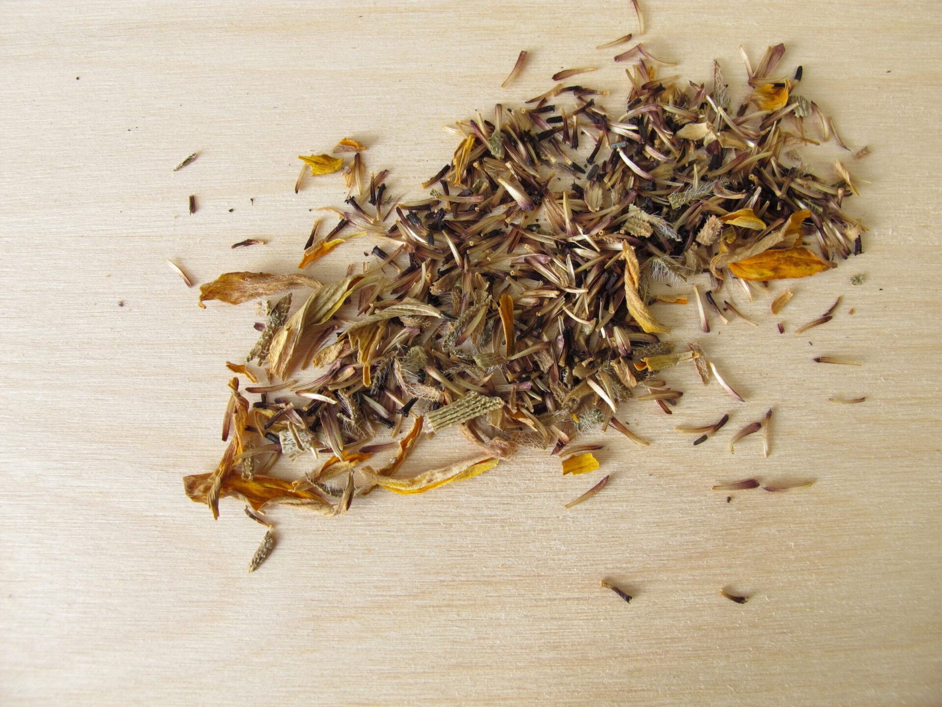 Scattered wildflower seeds on wooden surface